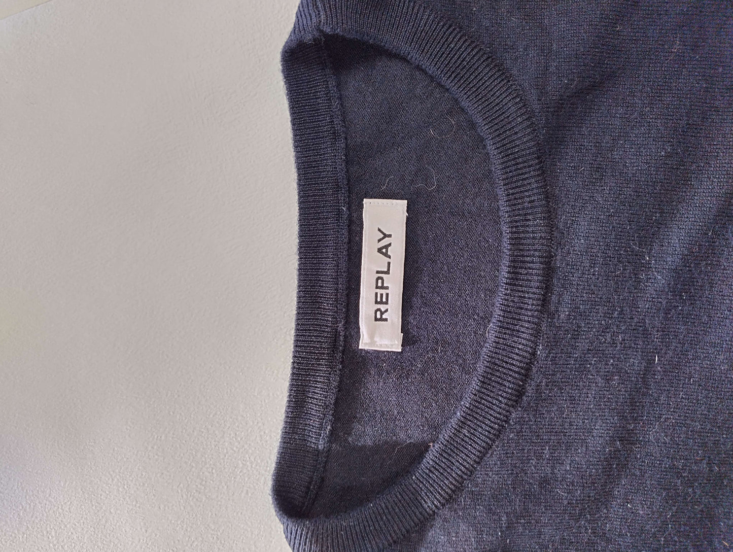 Close-up of sweater tag with brand name