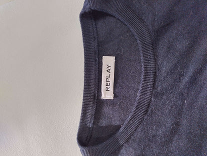 Close-up of sweater tag with brand name