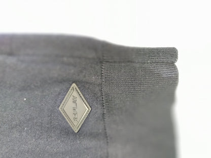 Close-up of sweater sleeve with logo