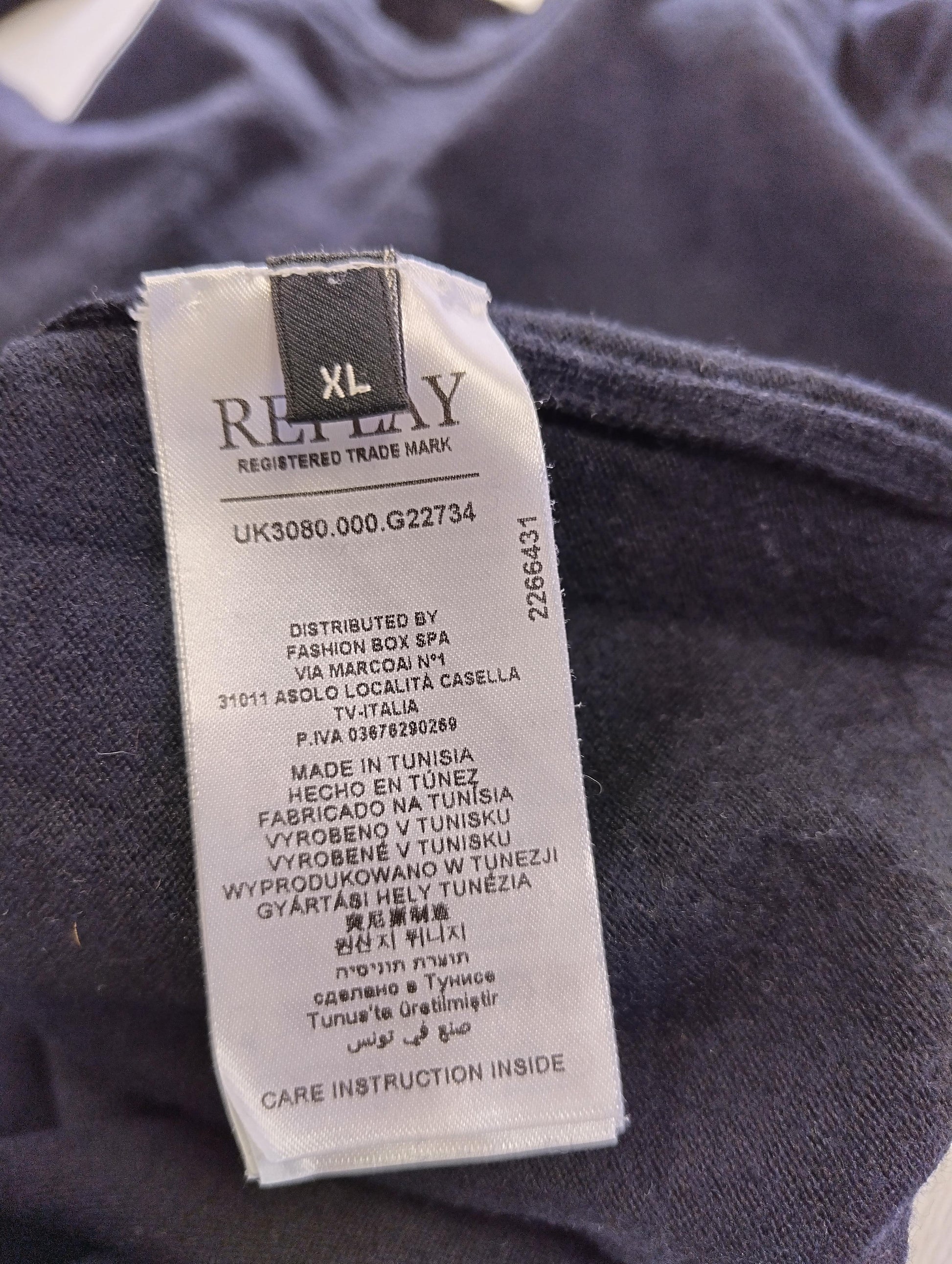 Close-up of sweater label with size information