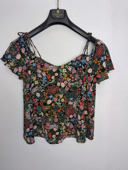 Floral print top on hanger front view