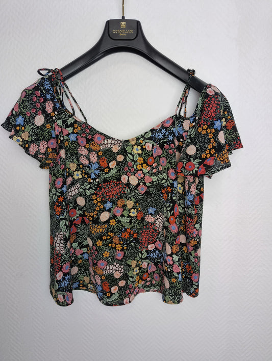 Floral print top on hanger front view