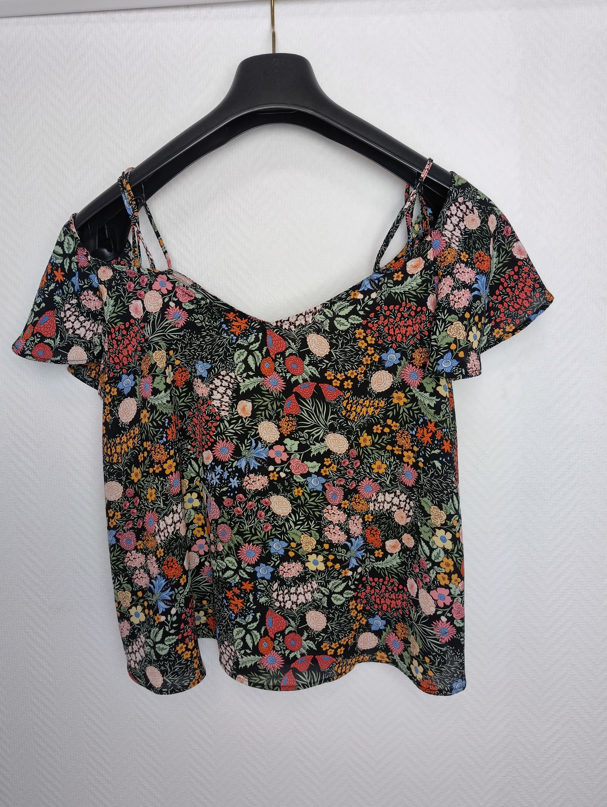 Floral print top on hanger back view