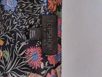 Tag showing Topshop brand and size