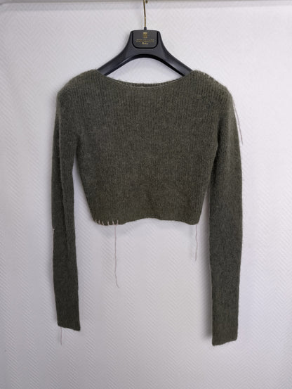 Back view of cropped sweater with hanger