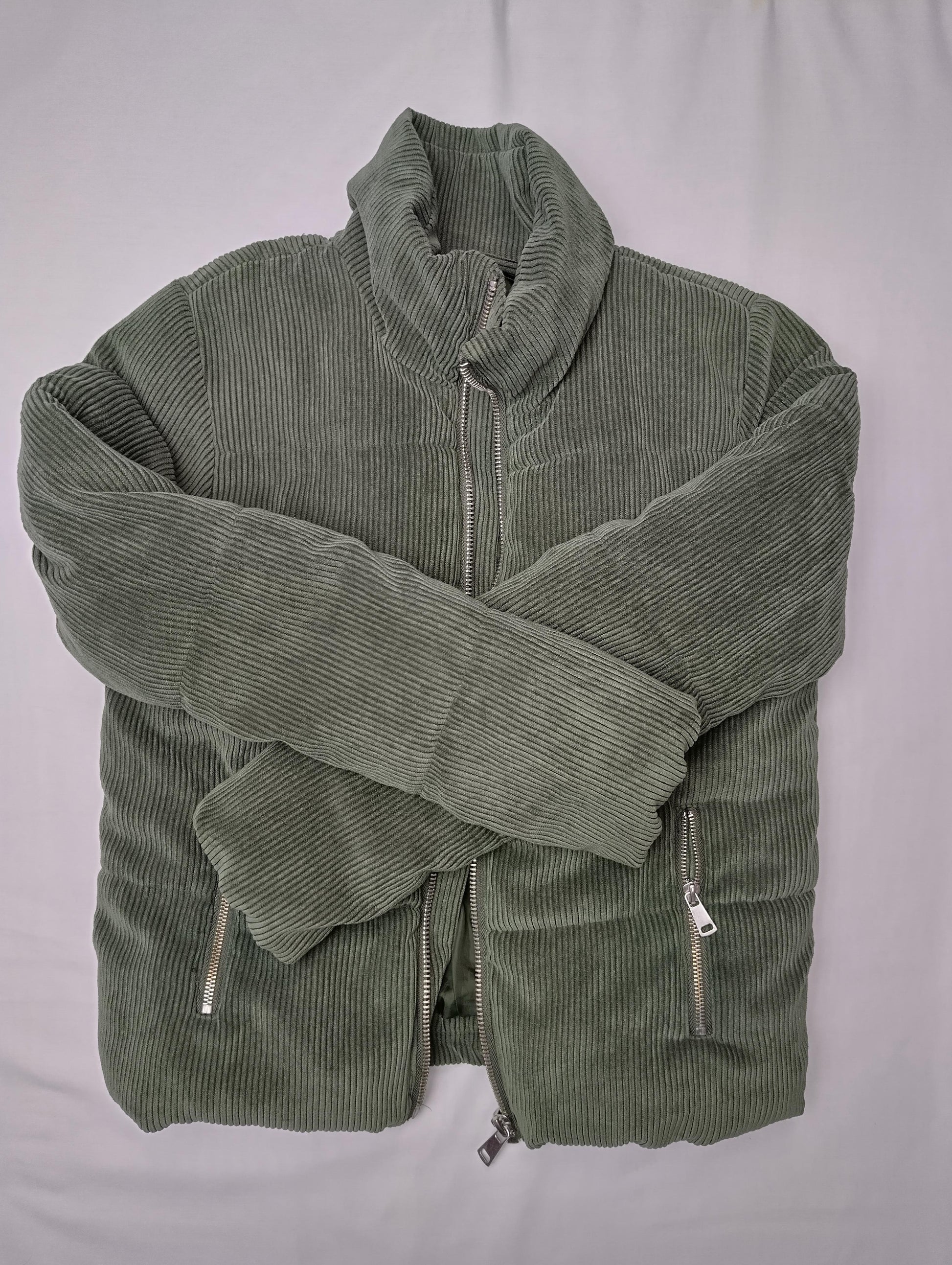 Folded olive green corduroy jacket