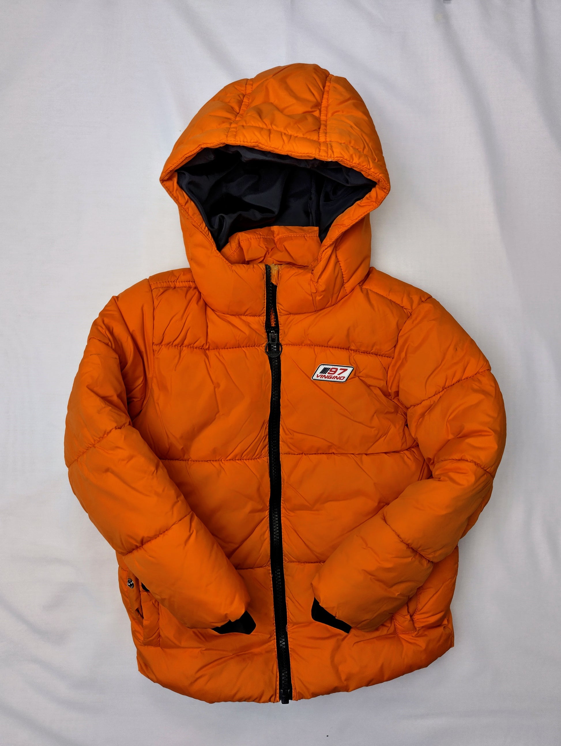 Front view of puffer jacket with hands folded