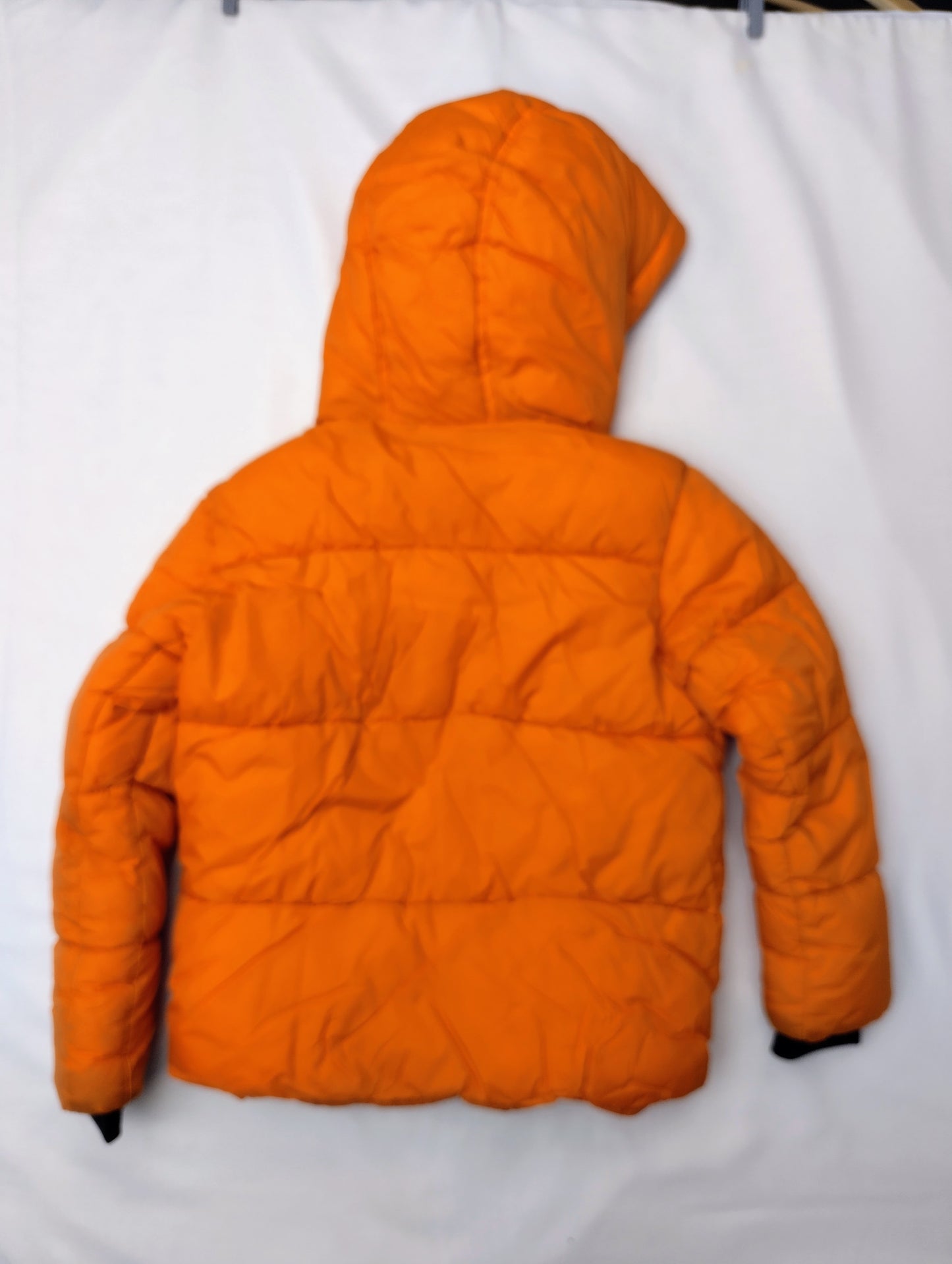 Back view of bright orange puffer jacket