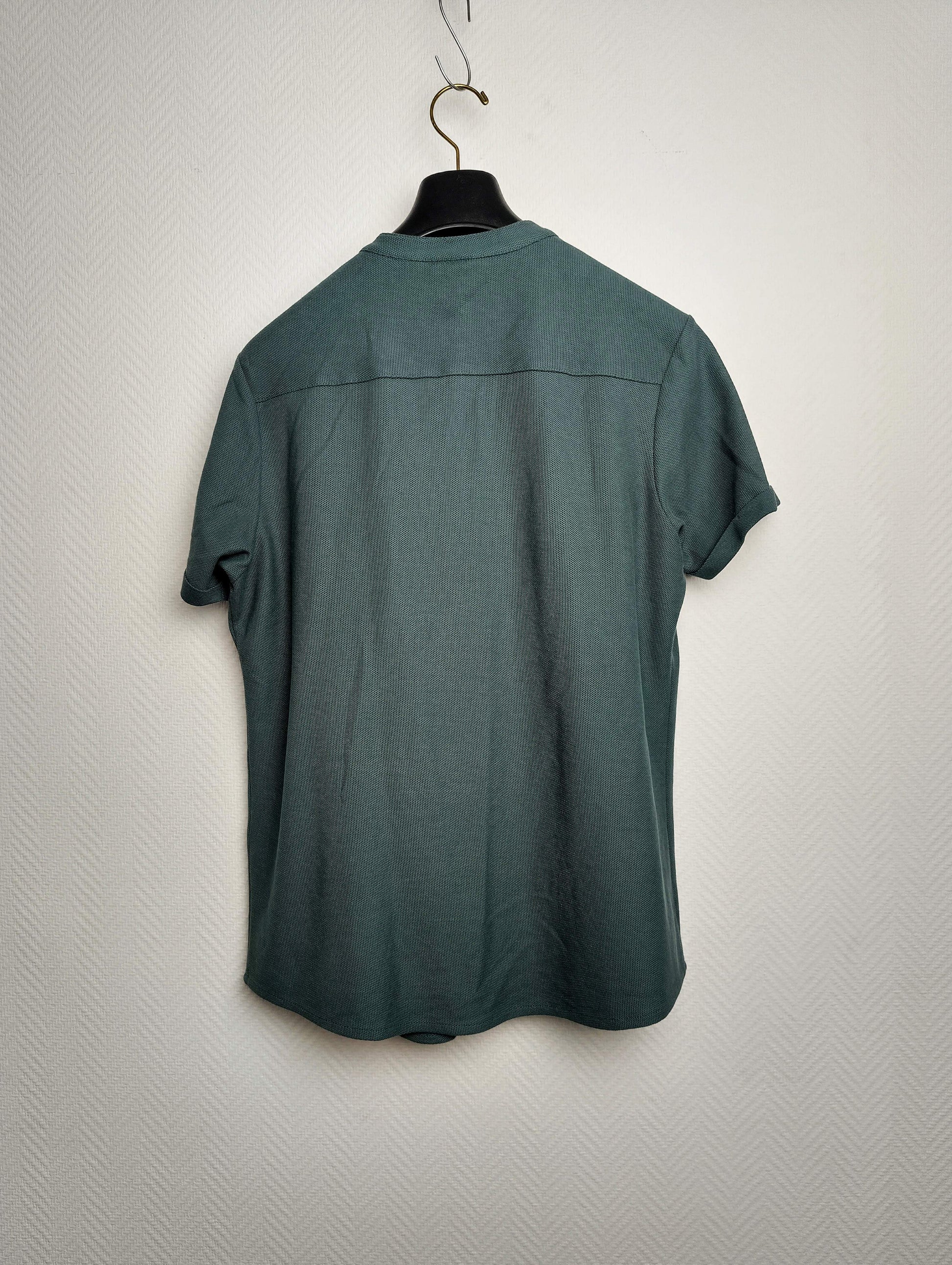 Back view of a dark green short-sleeve shirt