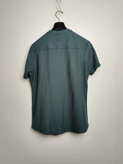 Back view of a dark green short-sleeve shirt