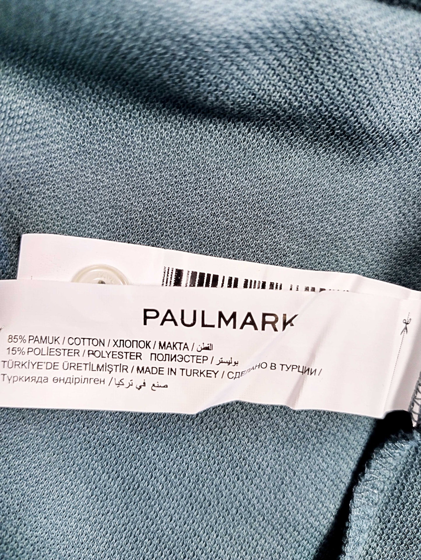 Tag showing material composition of the shirt