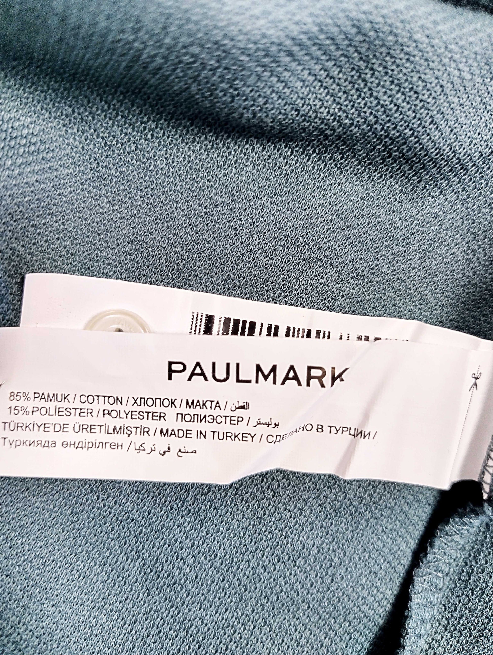 Tag showing material composition of the shirt