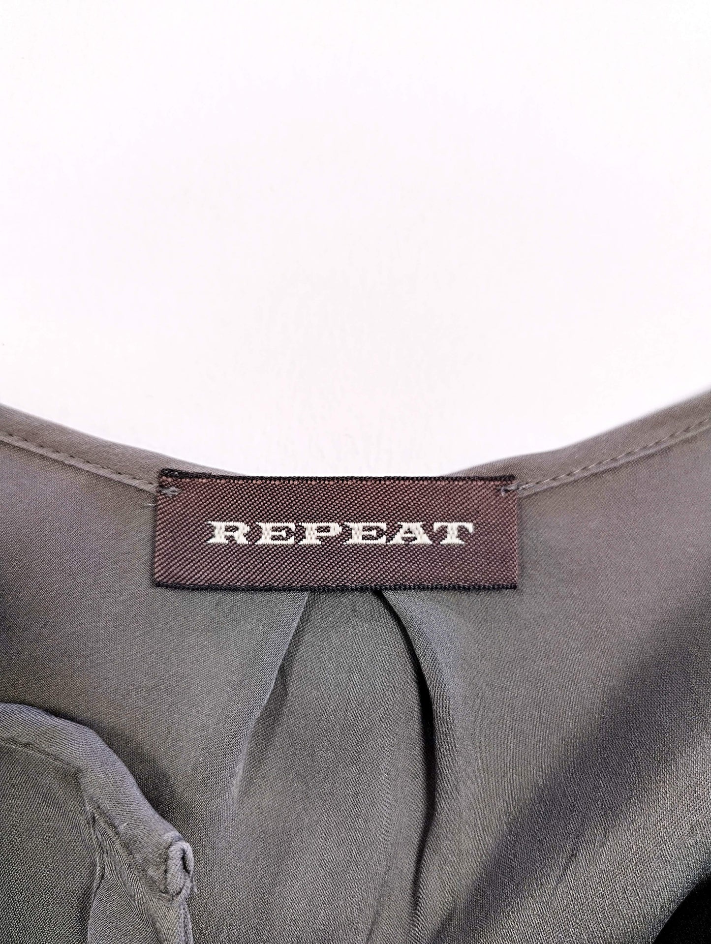 Close-up of the REPEAT brand tag