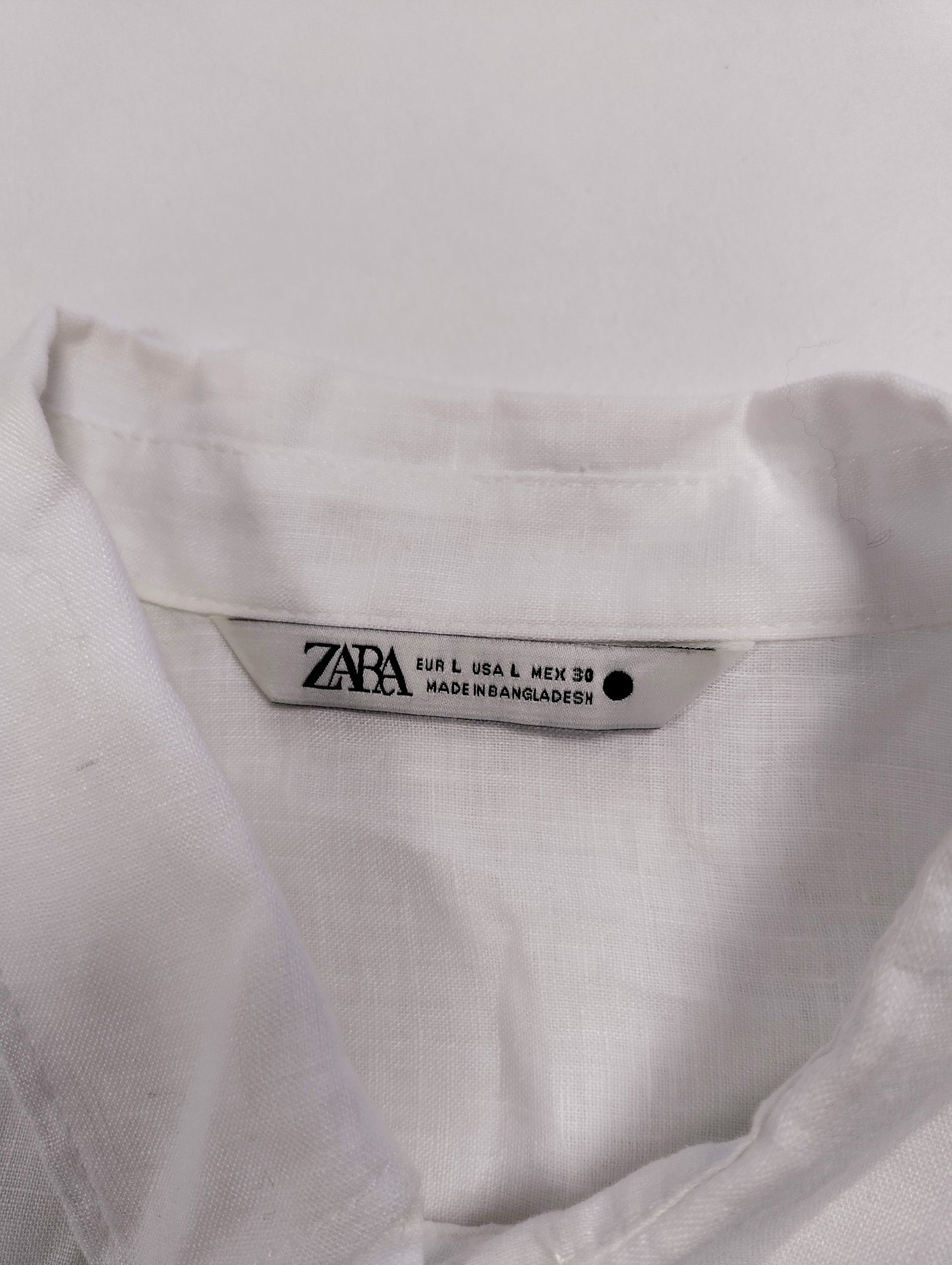 Close-up of the label on the white shirt