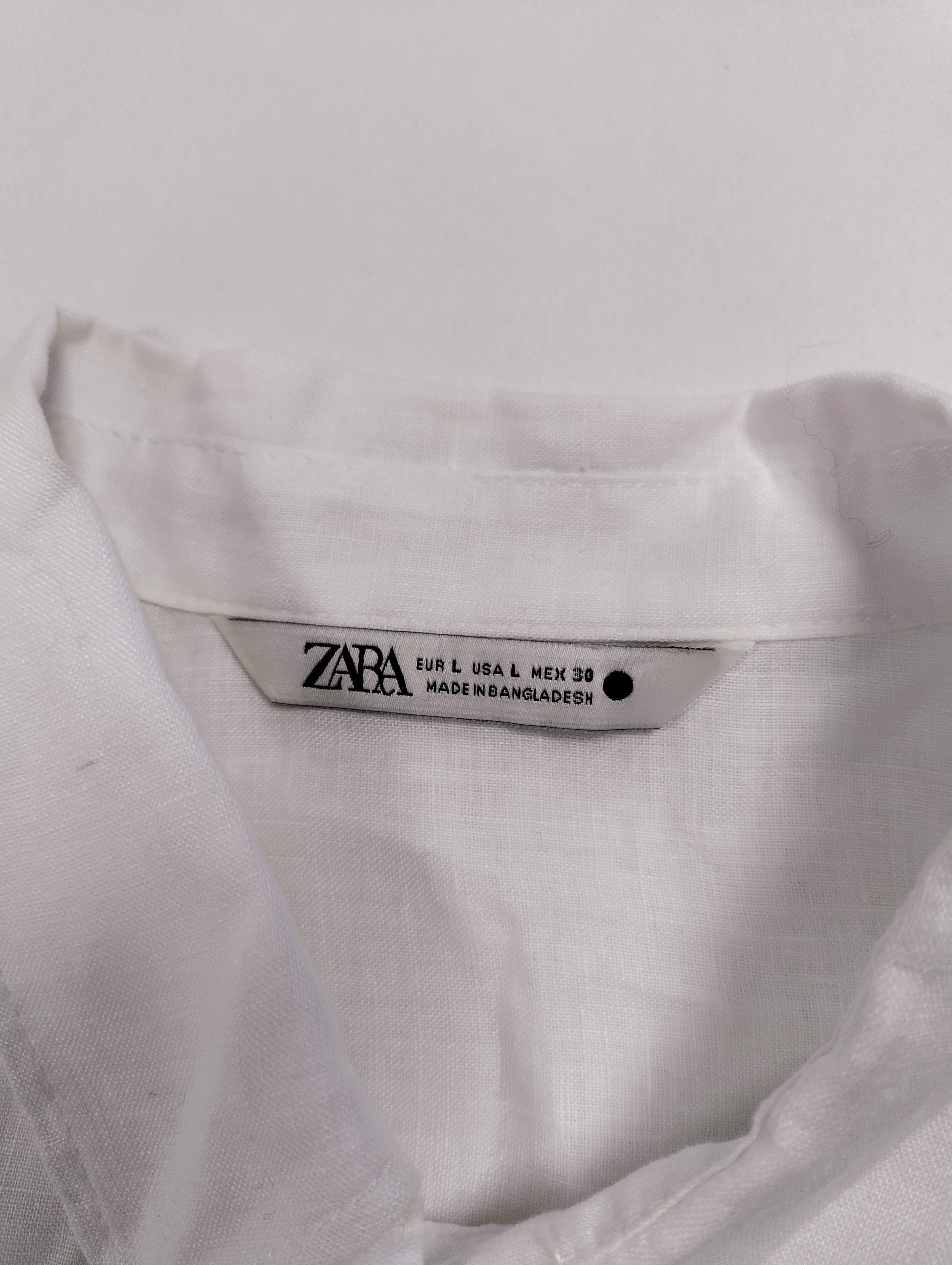 Close-up of the label on the white shirt