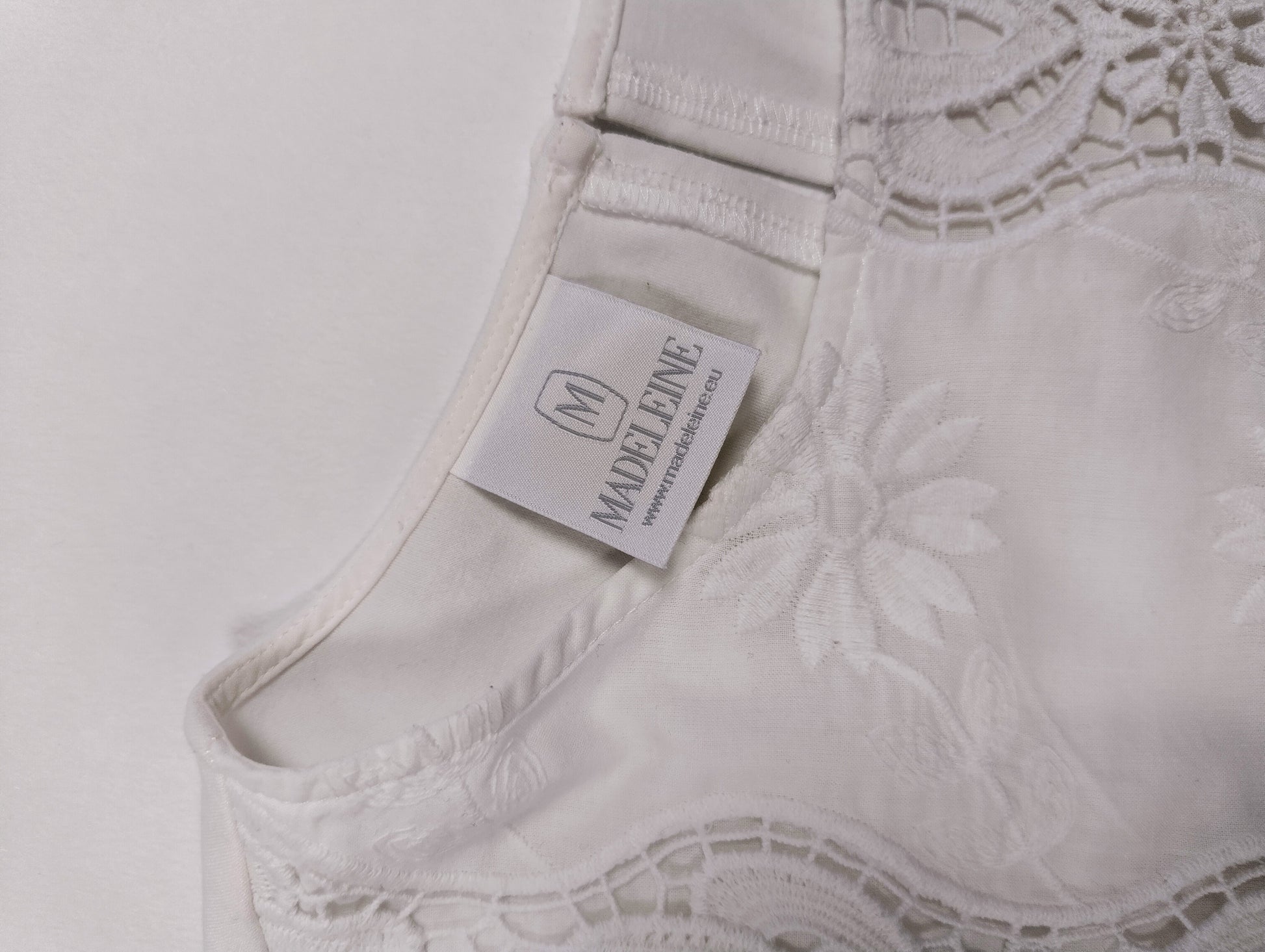 Close-up of the tag on the white blouse