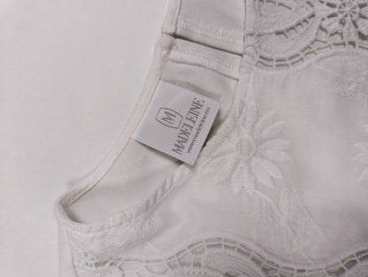 Close-up of the tag on the white blouse