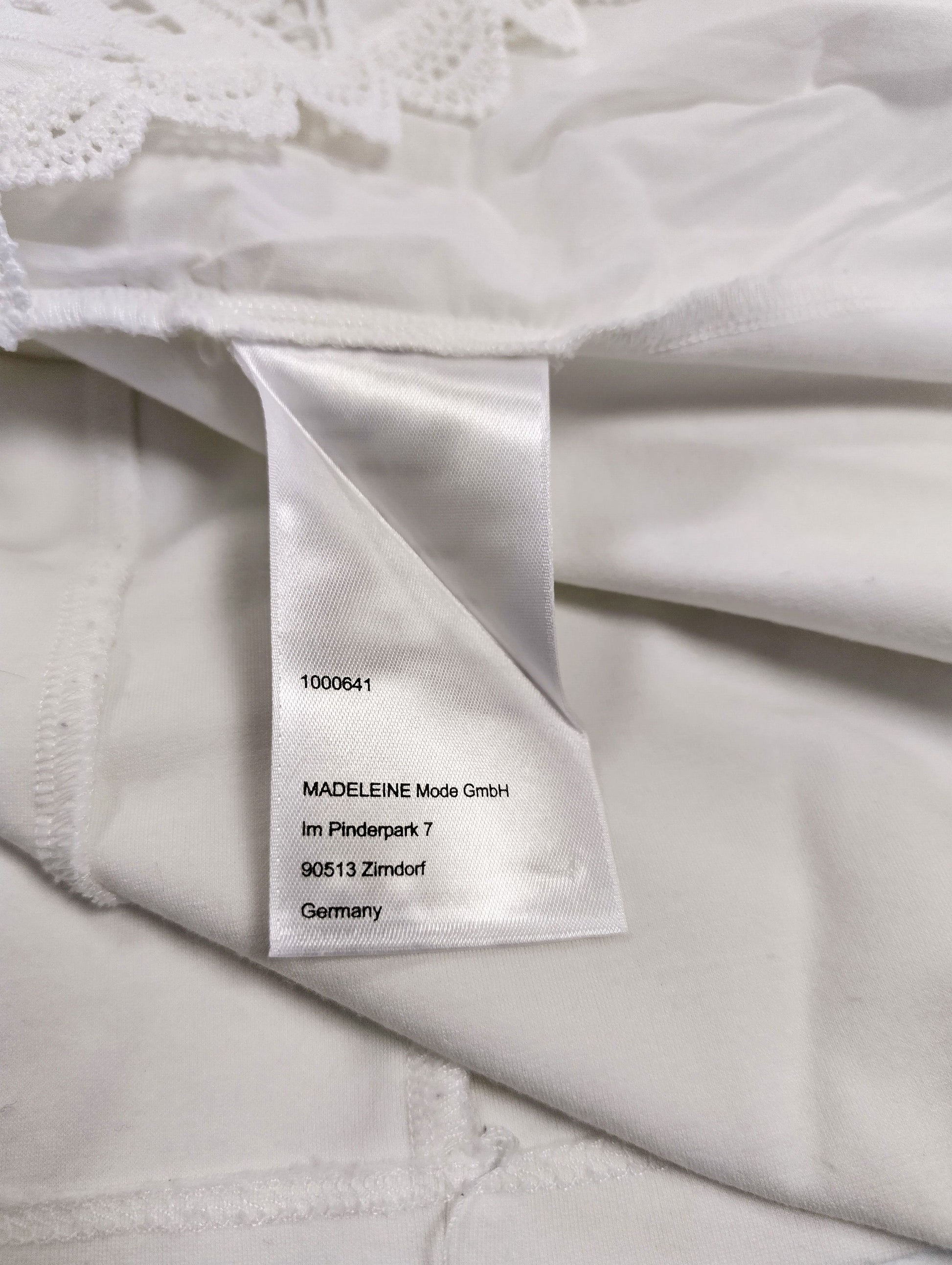 Close-up of the care label on the white blouse