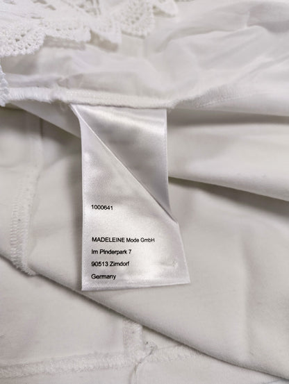Close-up of the care label on the white blouse