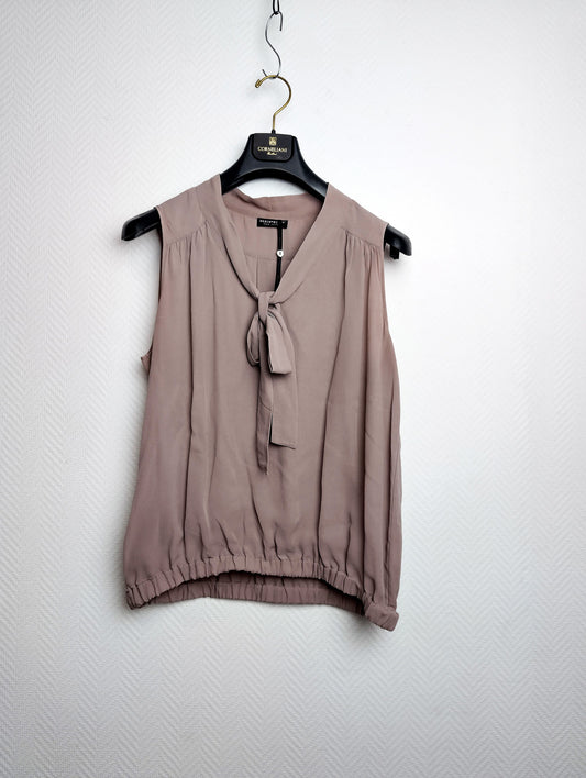 Front view of silk blouse on hanger