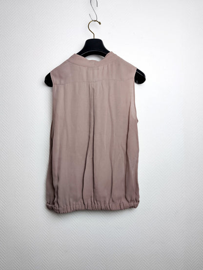 Back view of silk blouse on hanger