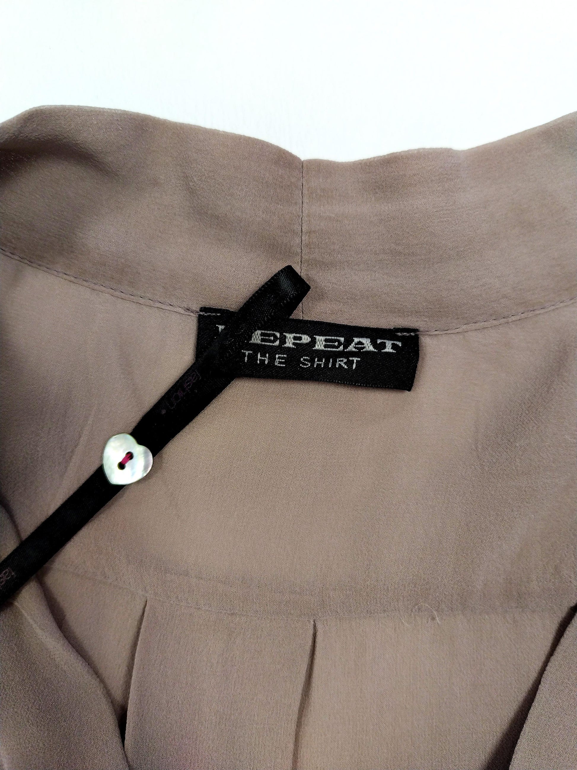 Close-up of blouse neckline and tag