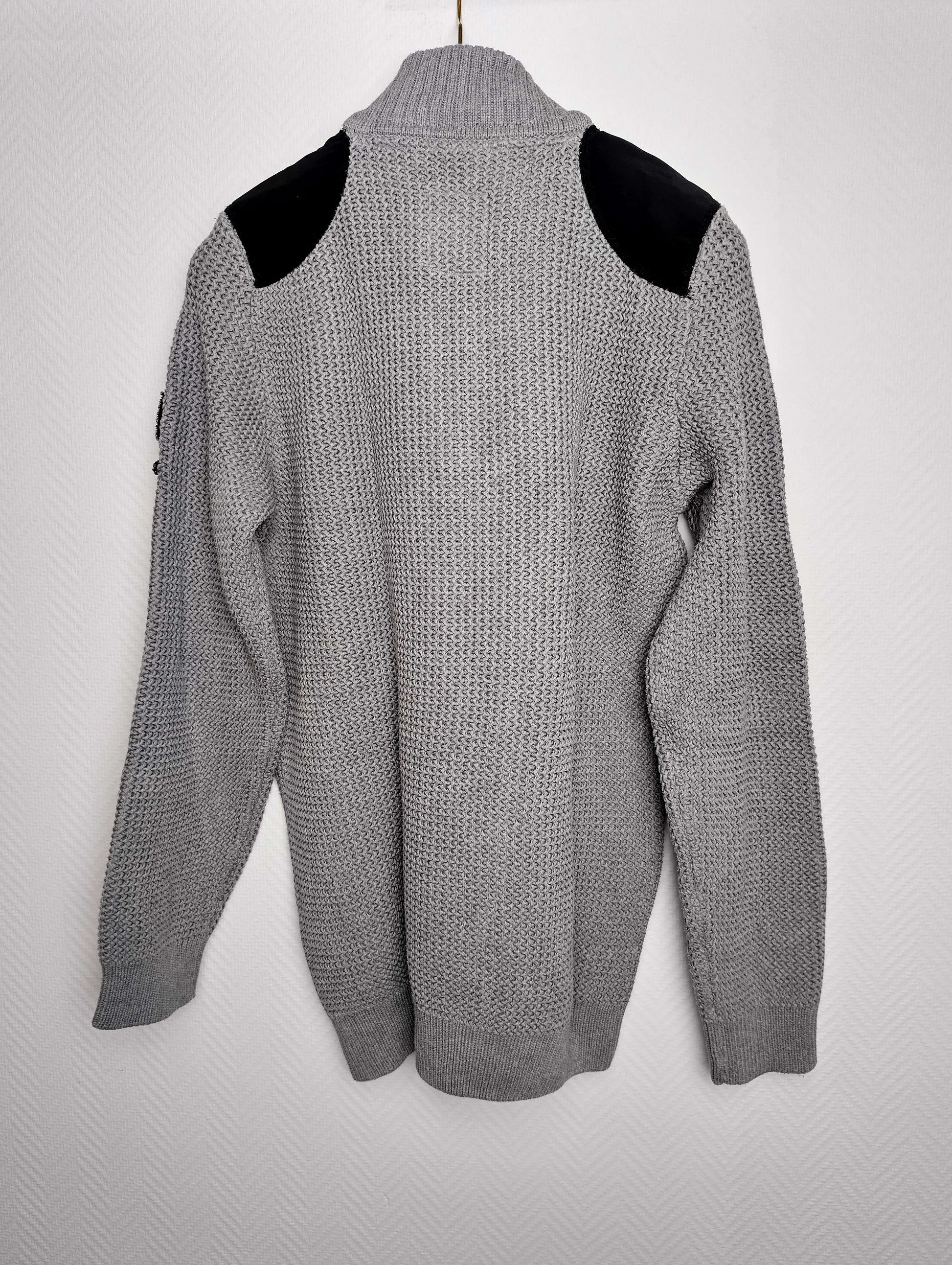 Back view of gray sweater with black shoulder accents