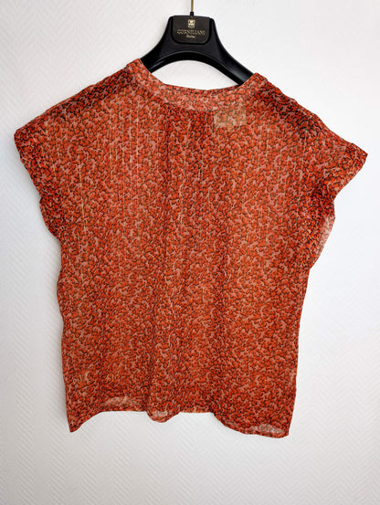Back view of the floral top on a hanger