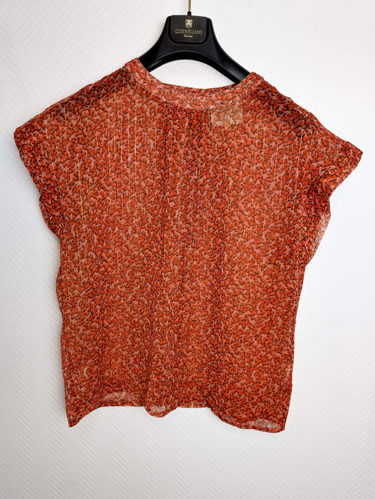 Back view of the floral top on a hanger
