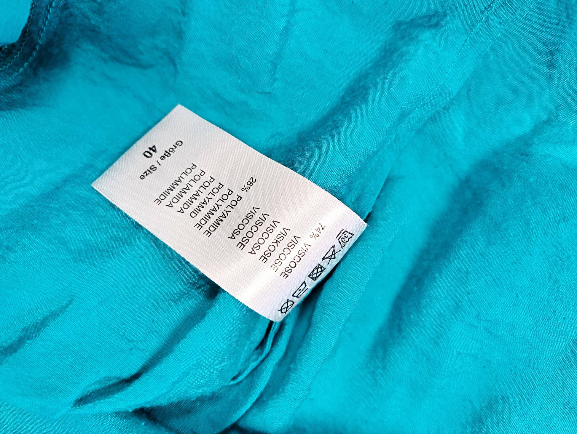 Care label of the teal blouse