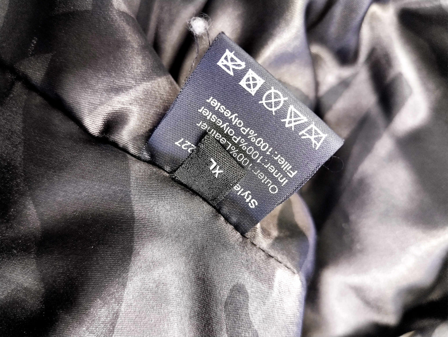 Care label of the jacket showing materials and instructions