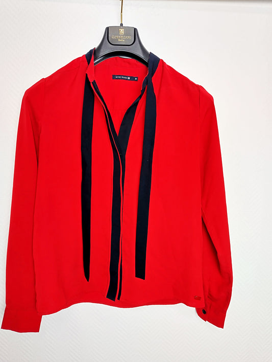 Front view of the red blouse with black accents