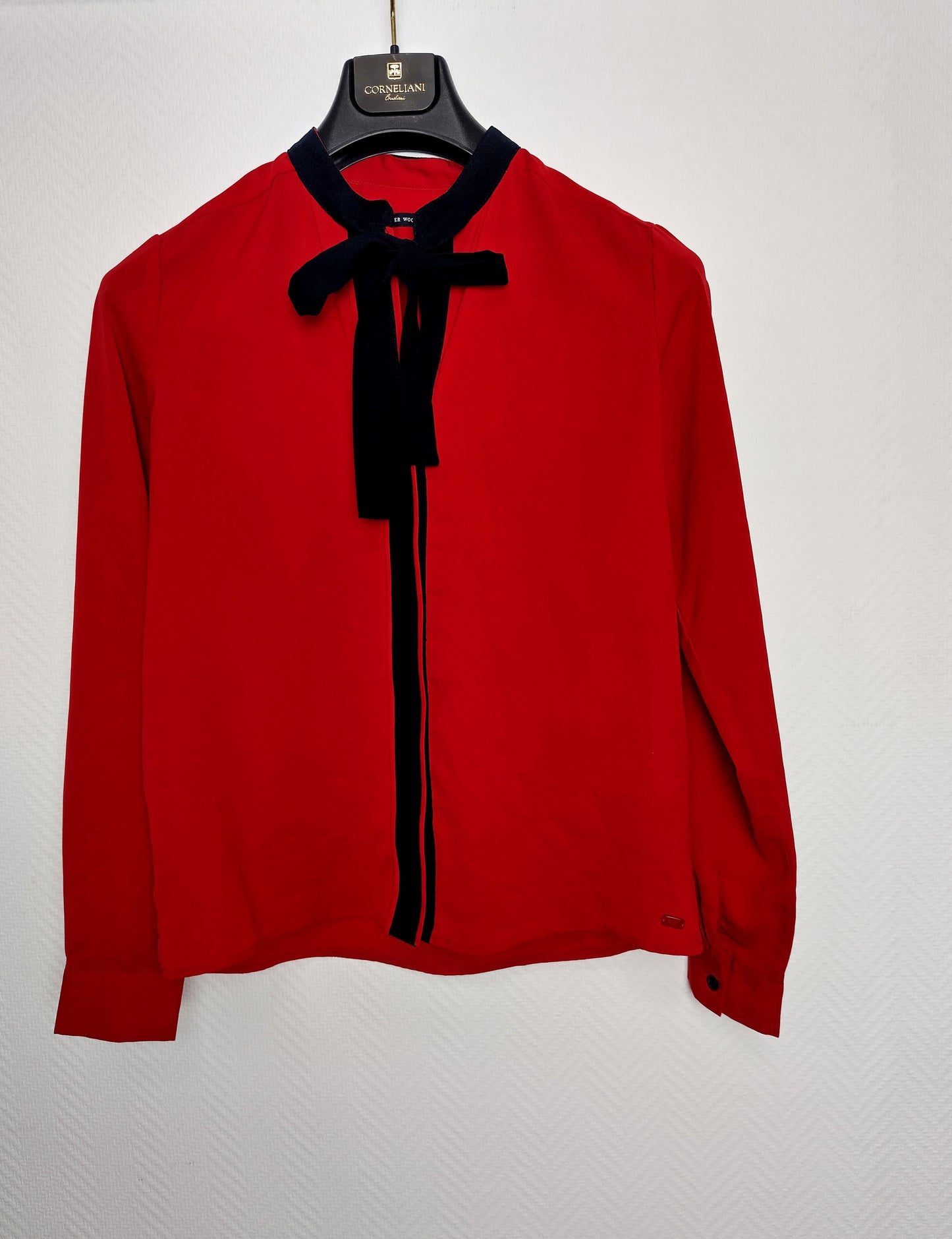 Front view of the red blouse with a tied collar