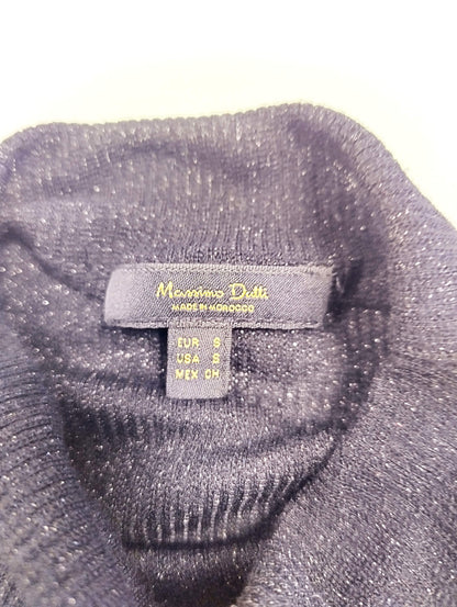 Label on the inside of black long sleeve top