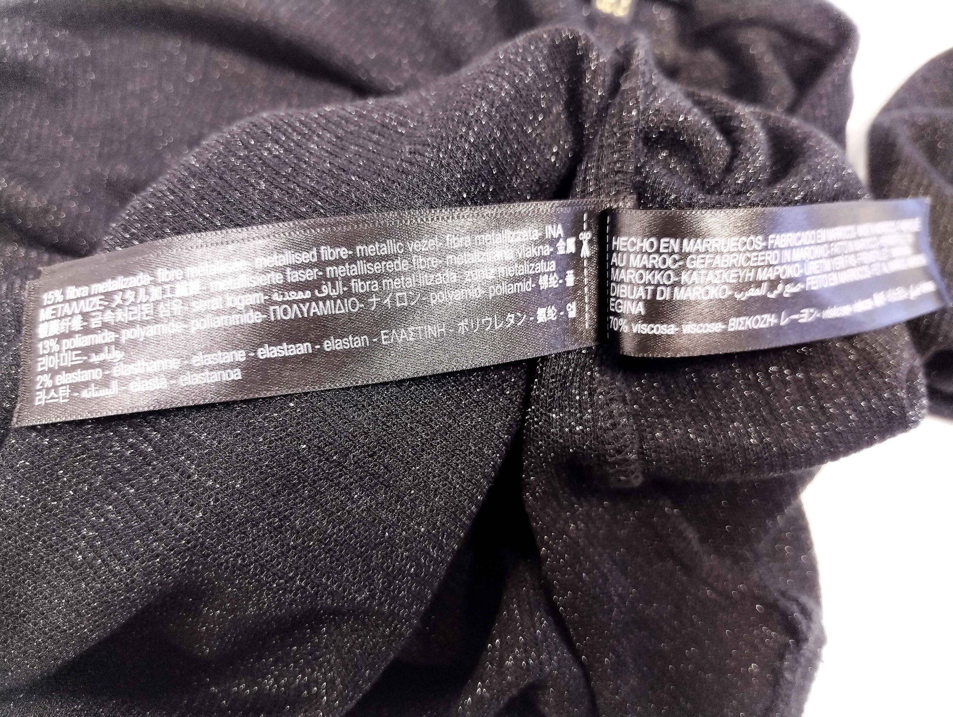 Care instructions label on black long sleeve top