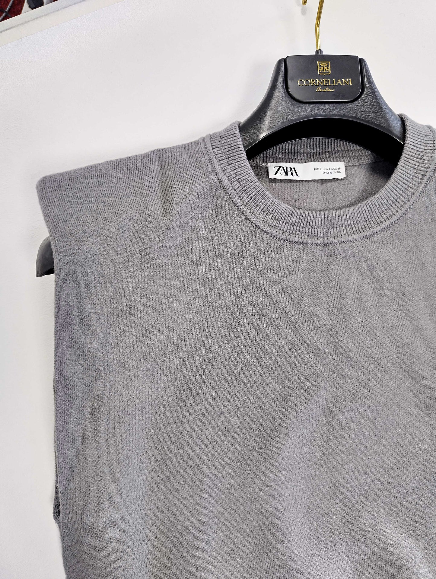 Close-up of grey sweater showing neckline