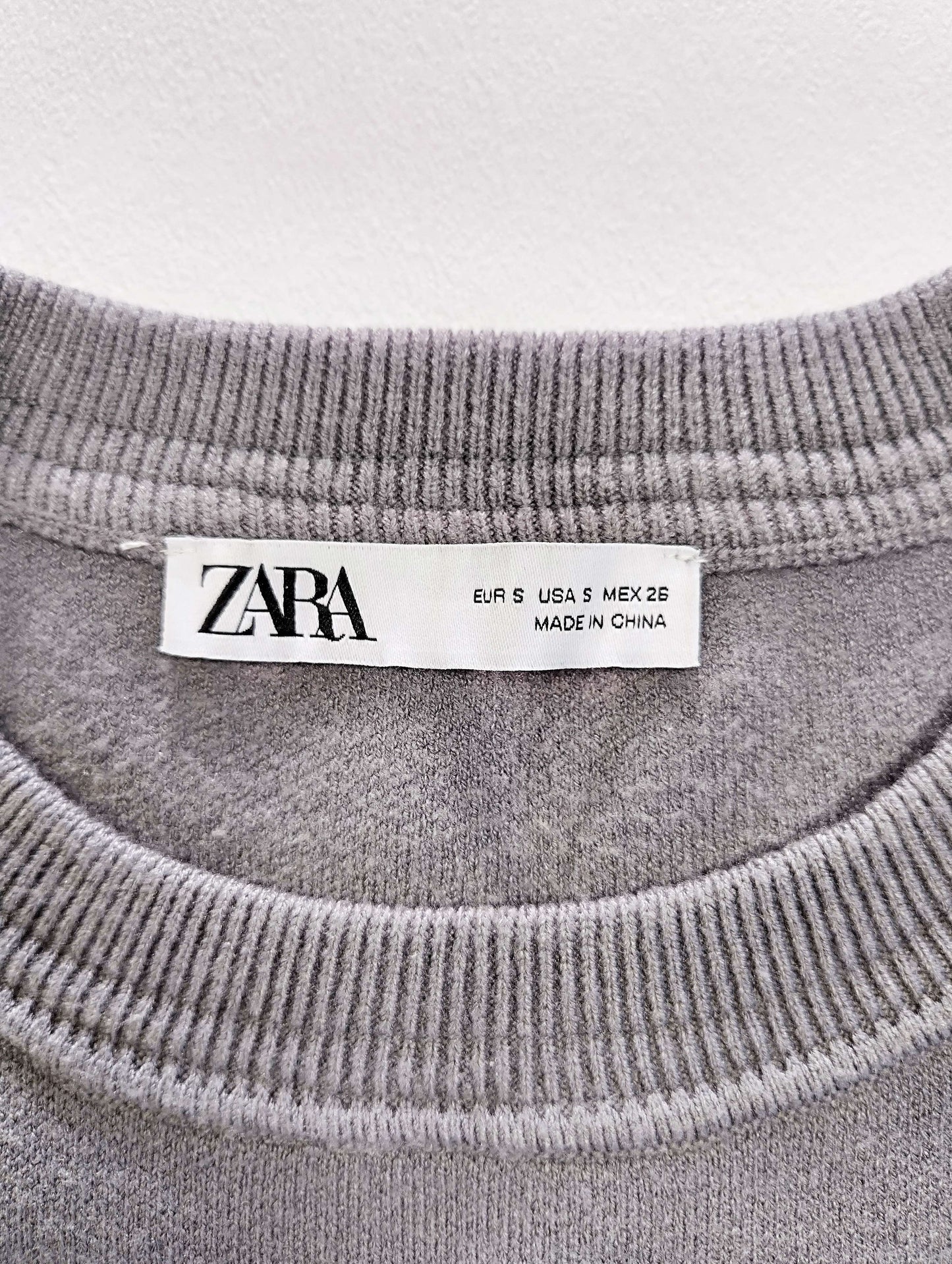 Label and size tag of Zara sweater