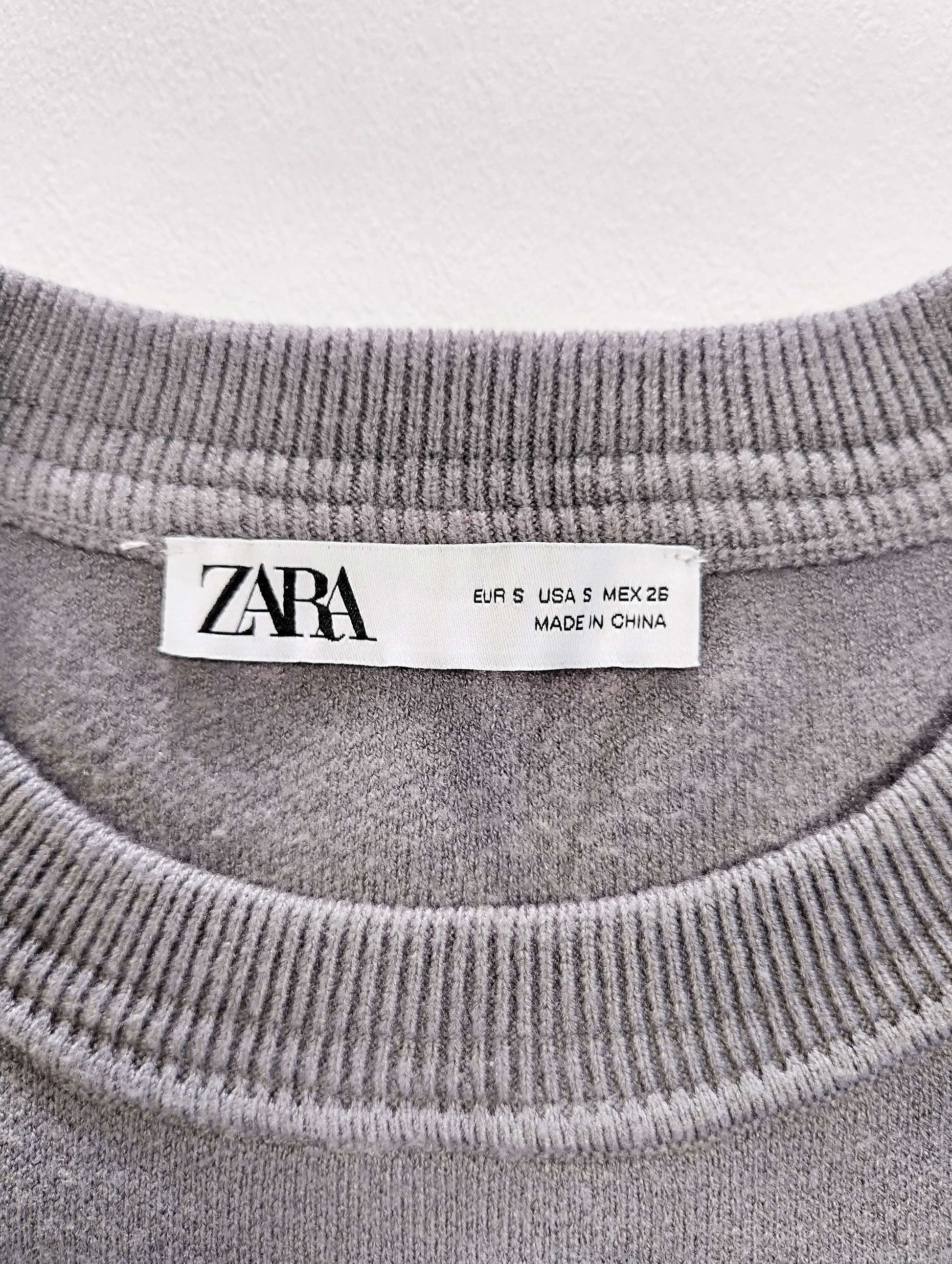 Label and size tag of Zara sweater