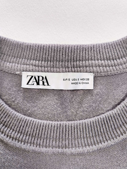 Label and size tag of Zara sweater