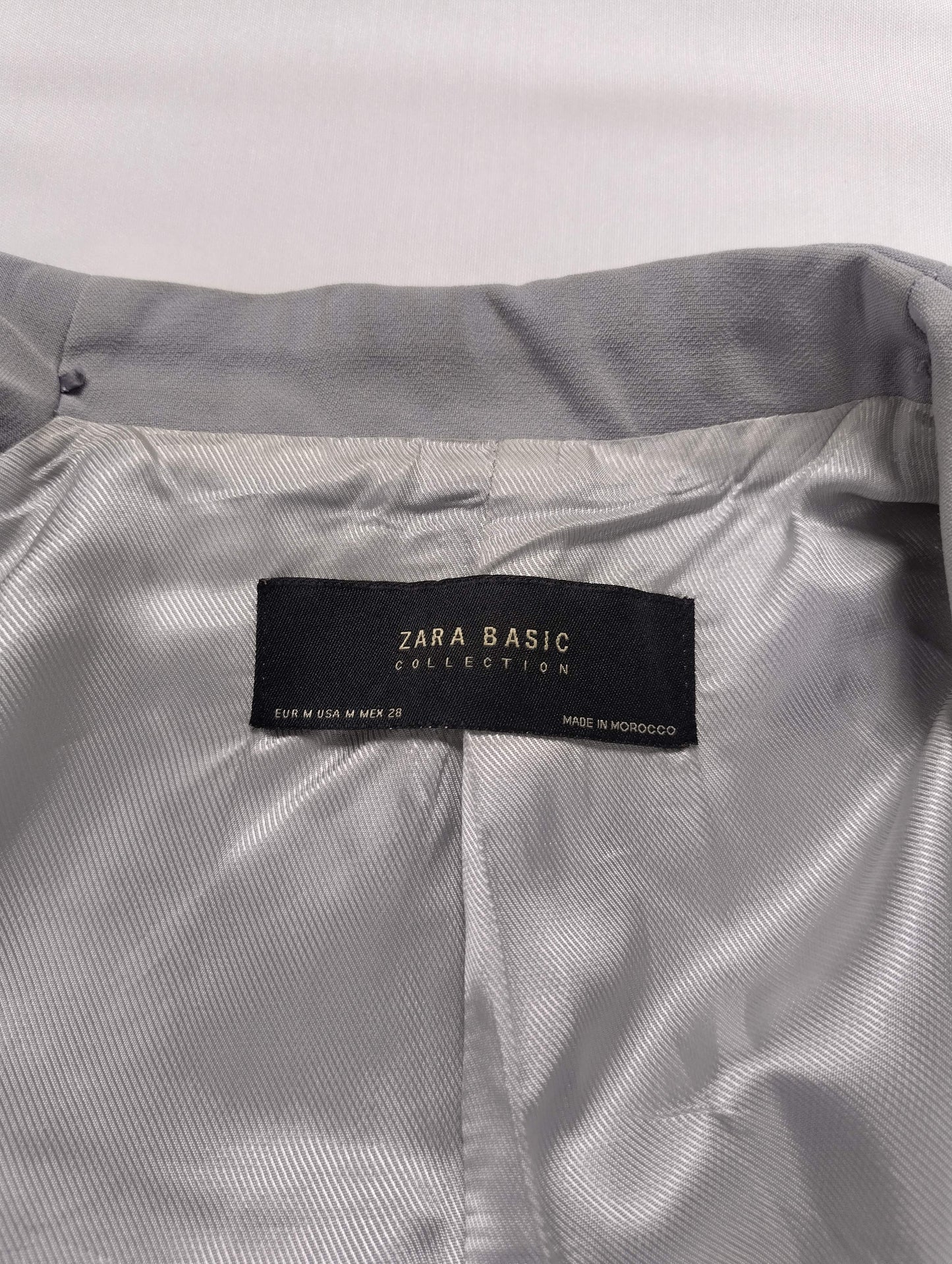 Close-up of Zara Basic label inside gray blazer