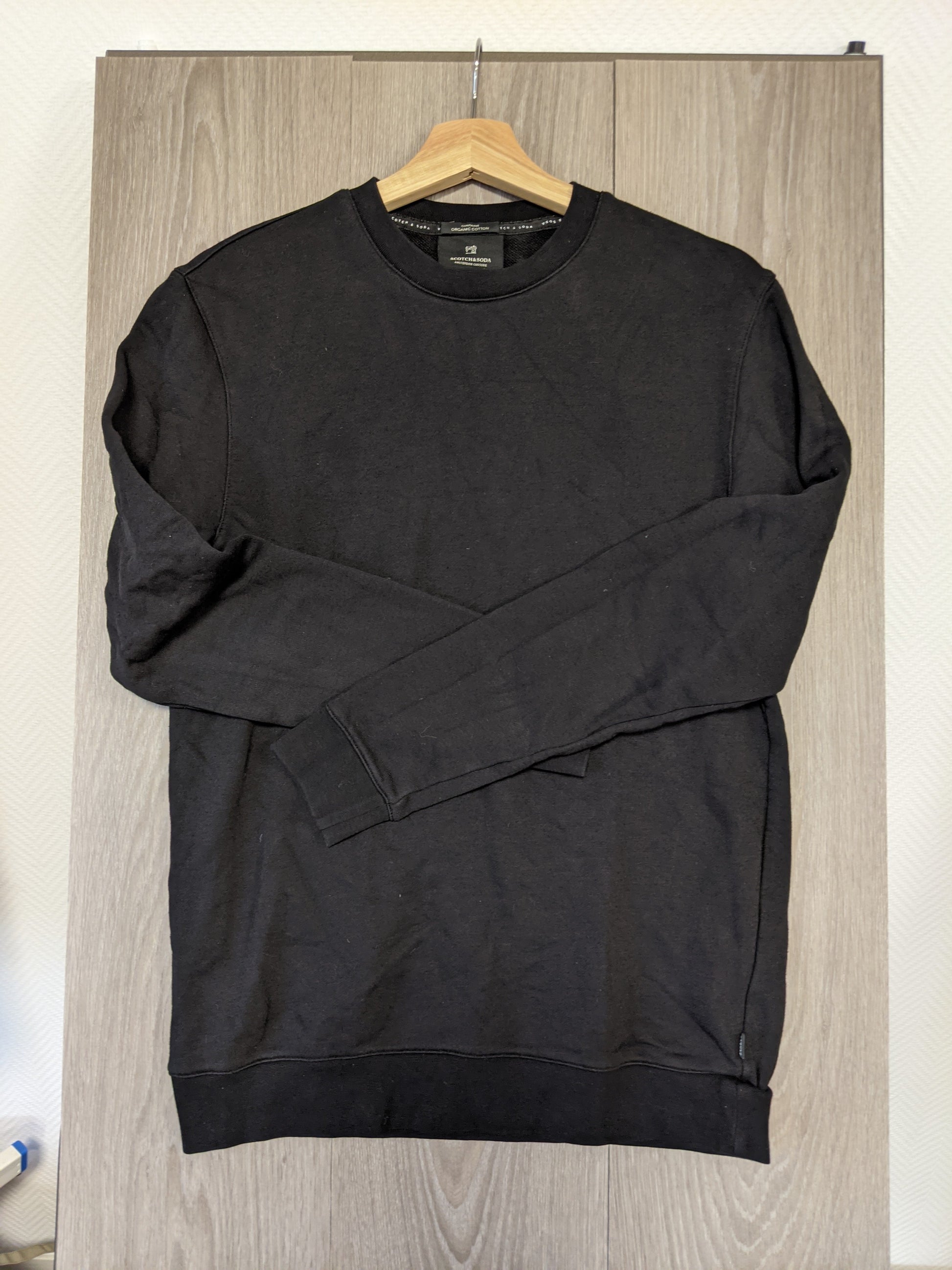 Another angle of black sweater hanging
