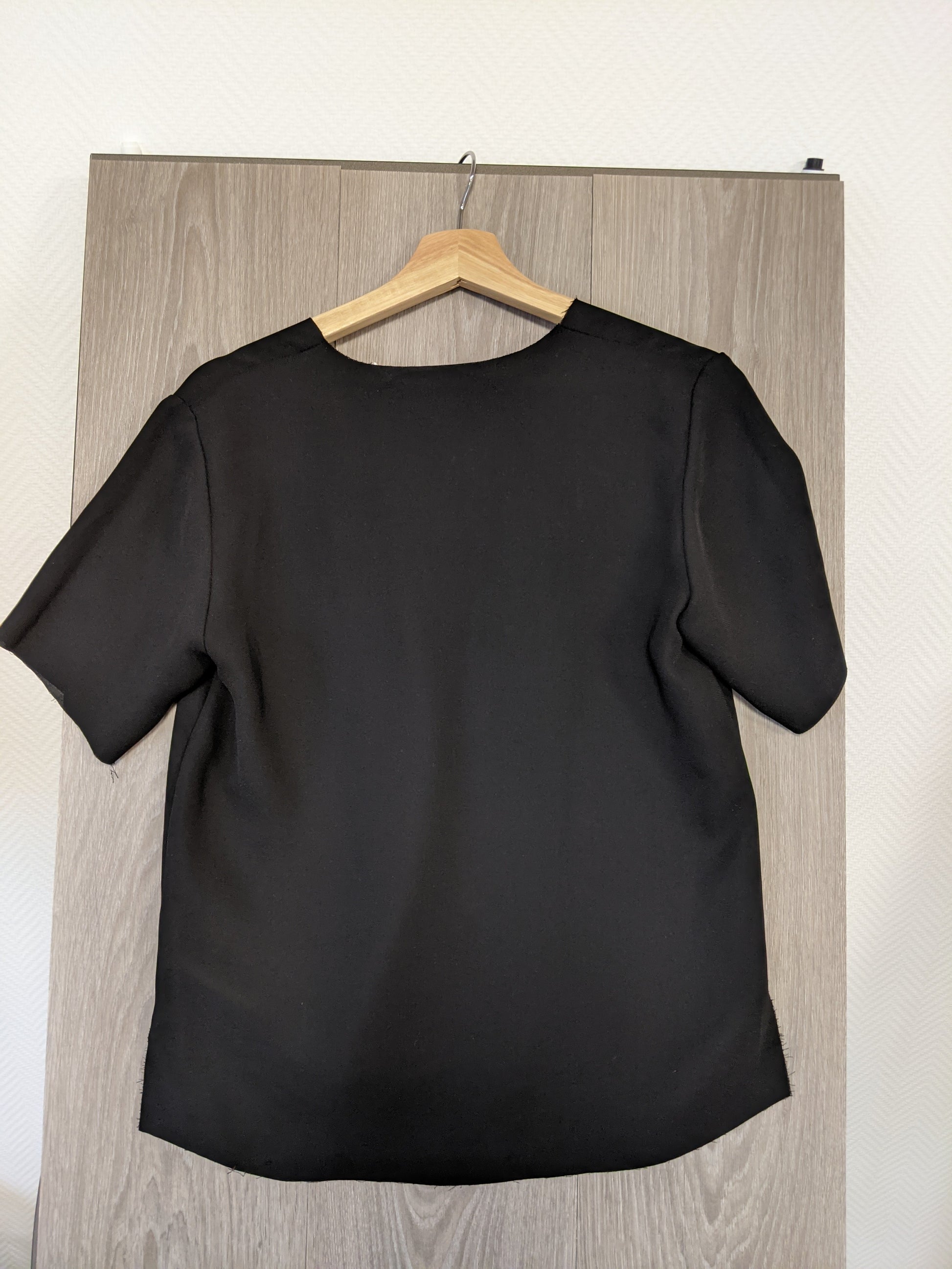 Black V-neck top back view