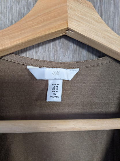 Close-up of size tag on brown bodysuit