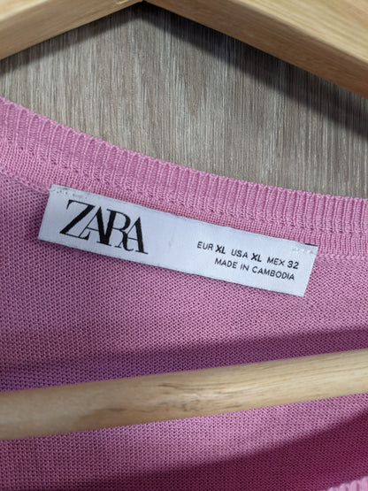Close-up of the label on the pink sweater