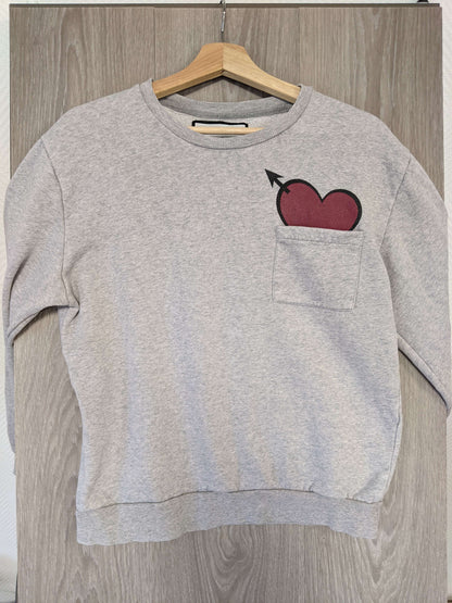 Front view of grey sweater with heart design