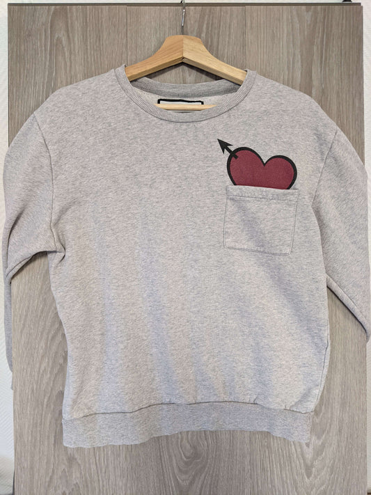 Front view of grey sweater with heart design