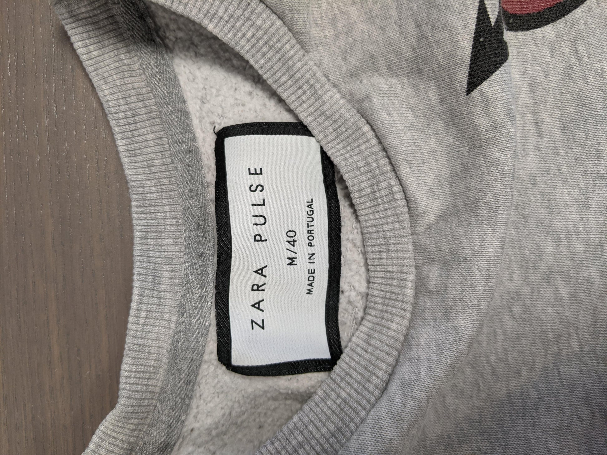 Close-up of the label on the grey sweater