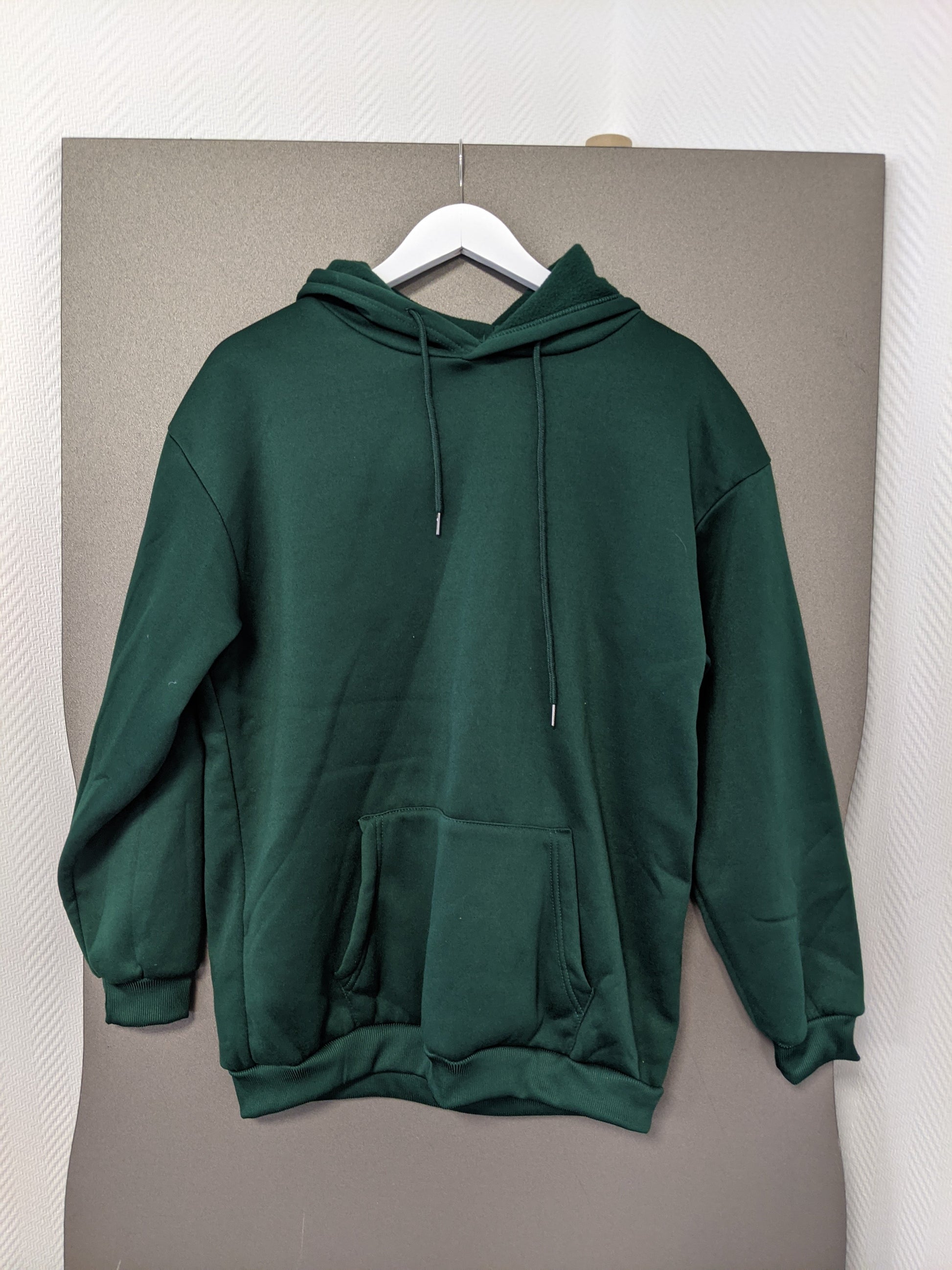 Front view of green hoodie on hanger