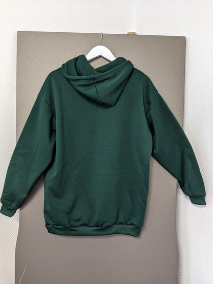 Back view of green hoodie on hanger