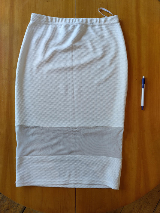 White skirt laid flat on wooden table